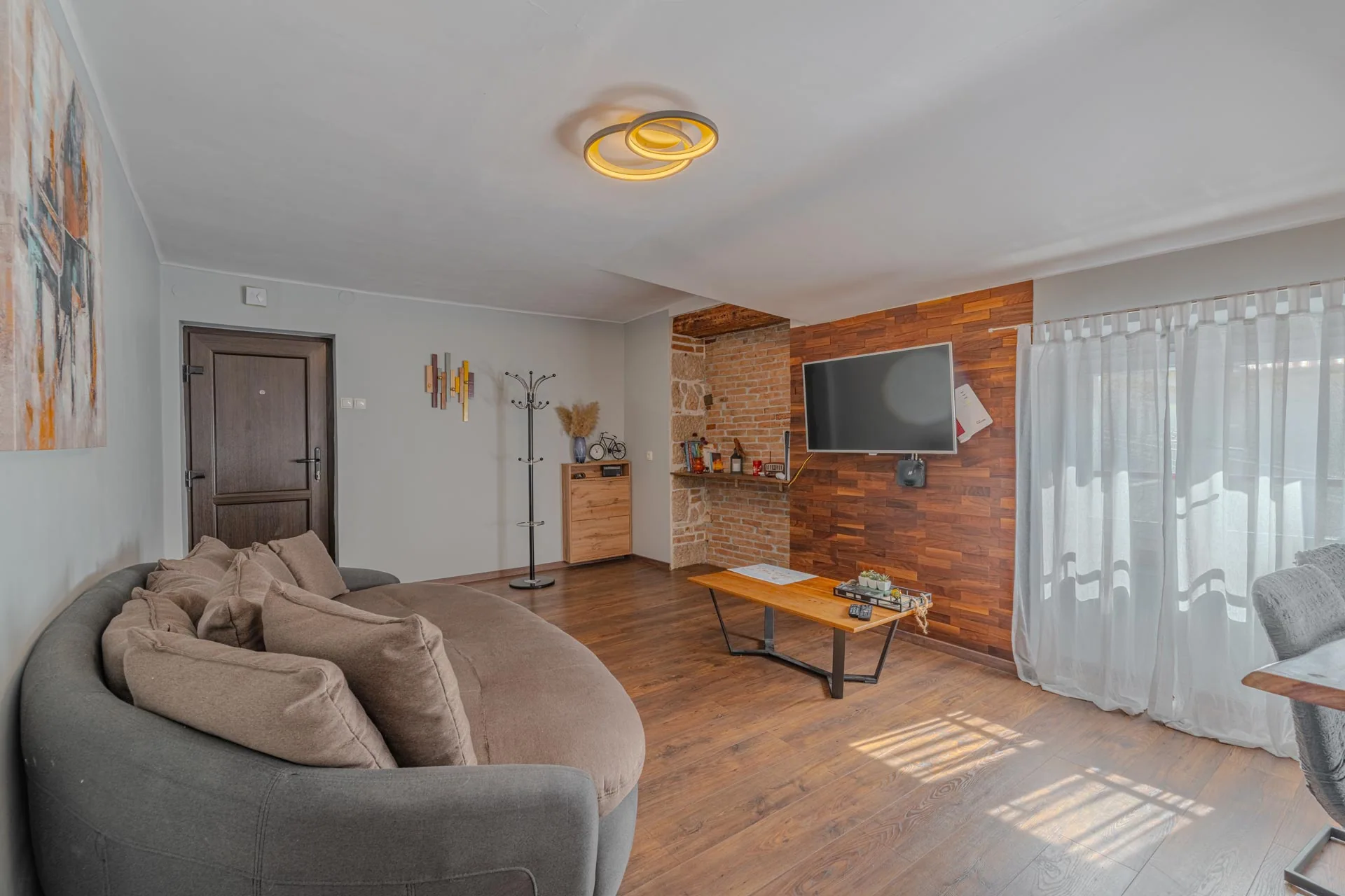 Living room with natural wood, brickwork and sofa