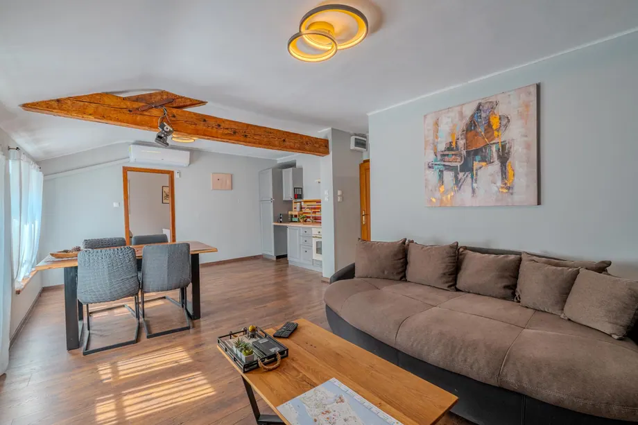 Living room with natural wood, brickwork and sofa
